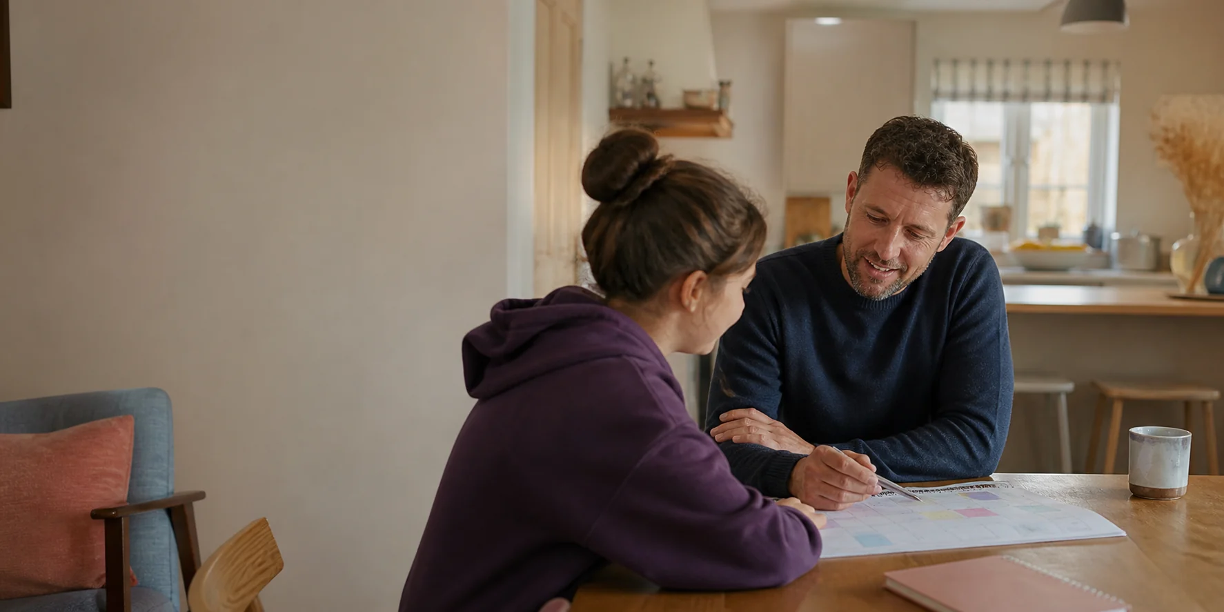 A residential care practitioner and young person planning together in a welcoming home